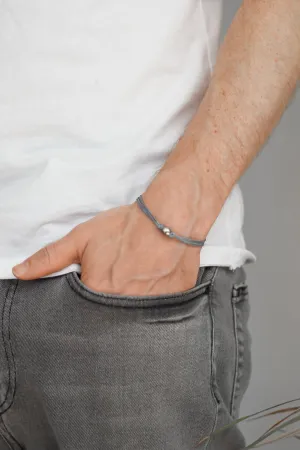 Men's bracelet with silver bead charm and a gray cord